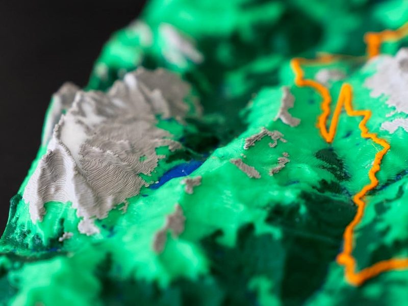 Macro detail of peaks and an orange GPX line on a 3D printed elevation relief